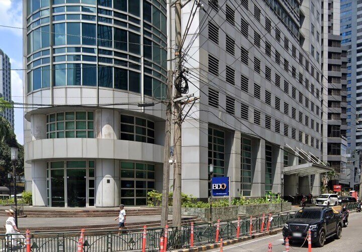 Exterior view of the BDO bank branch in a modern glass and concrete office building along a street