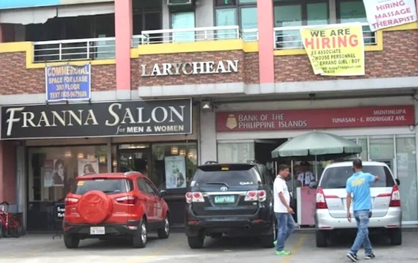 The exterior of the Larychean commercial building featuring a Franna Salon and a Bank of the Philippine Islands (BPI) branch, with three cars parked in the foreground