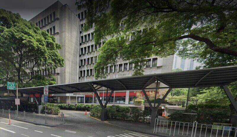The exterior of the Bank of the Philippine Islands (BPI) head office in Makati, featuring its brutalist concrete architecture and a street-level waiting shed