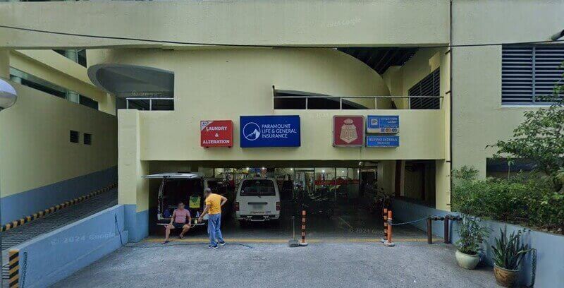 Exterior view of a BPI branch located at the corner of 30th Street in Bonifacio Global City (BGC), featuring its red-branded entrance, sidewalk trees, and a "No Parking" sign in the foreground