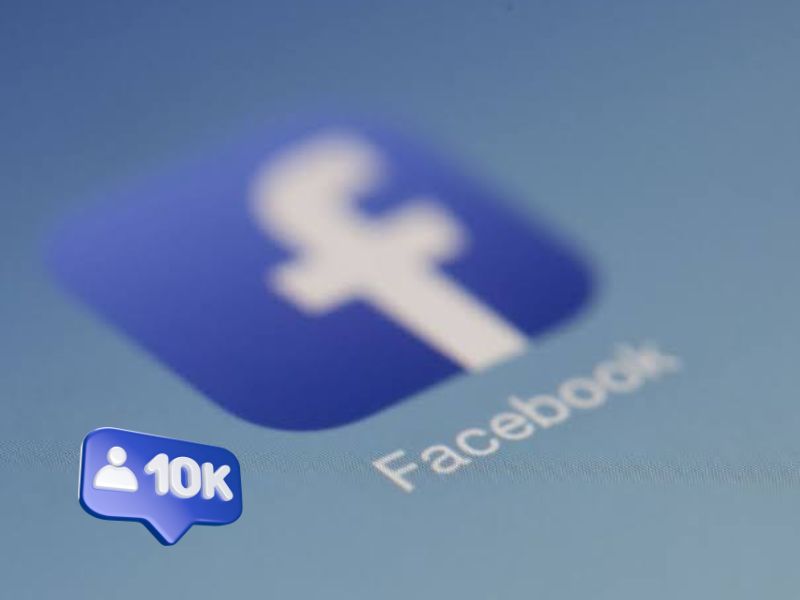 Close-up of the Facebook logo on a screen with a 3D blue speech bubble icon displaying "10K" and a user symbol, representing follower count